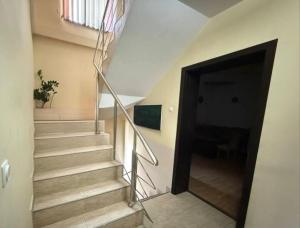 a stairway with a door and a stair case at Alfa Mall in Sibiu