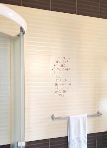a bathroom with a wall with a flower design on it at Alfa Mall in Sibiu