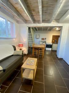 a living room with a couch and a table at Les Gîtes de Leymandie in Saint-Avit-de-Vialard