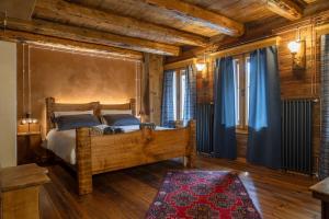 a bedroom with a bed in a room with wooden walls at Ristoro la Crosetta in Caneva