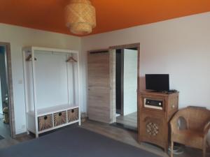 a living room with a tv and a wooden cabinet at Veronique schouckens in Binche