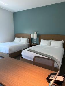 a hotel room with two beds and a table with a remote control at Element by Marriott Sedona in Sedona