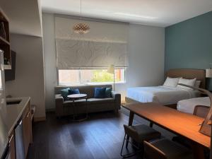 a hotel room with a bed and a couch and a table at Element by Marriott Sedona in Sedona