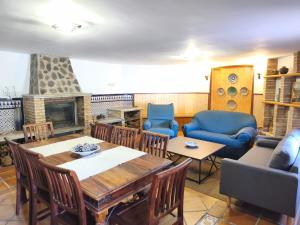 a living room with a table and a fireplace at El encinar de las nieves - Piscina privada, cerca de Toledo y Puy du Fou in Toledo
