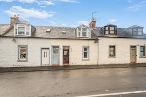a white building with windows on a street at 2 Bed in Dalrymple oc-b40270 in Dalrymple