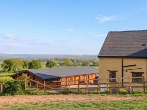 a large barn with a fence in front of it at Palace Studio in Hereford