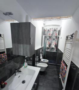 a bathroom with a white sink and a toilet at Casa Giorgia with Parking Space in Genoa +61 photos