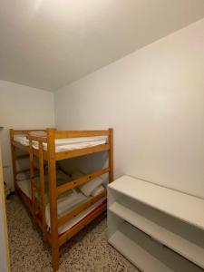 a small room with two bunk beds in it at Residence Port Saint Ange in Le Barcarès