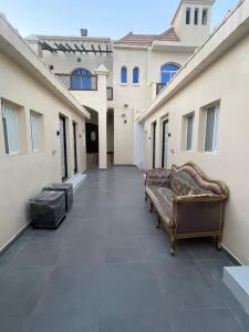 a hallway of a house with a couch on the floor at Garden Villa 4, Ajman in Ajman 