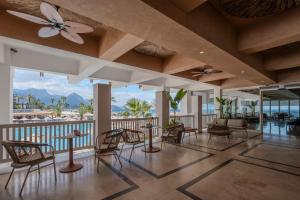 a living room with chairs and tables and a balcony at Corendon Hydros Club Kemer - Ultra All Inclusive in Kemer