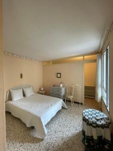 a bedroom with a bed and a desk and a window at Residence Port Saint Ange in Le Barcarès
