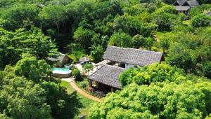 an aerial view of a house in the forest at Ecolodge Nosy Faly in Nosy Be