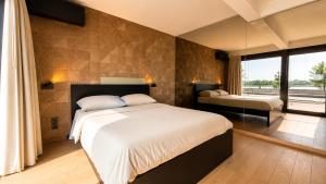 a bedroom with a large bed and a large window at Antwerp Design Stay with Panoramic River Views in Antwerp