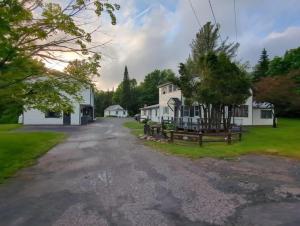 an empty road in front of two white houses at Woodford Rest in Woodford