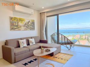 a living room with a couch and a table at CĂN HỘ CAO CẤP THE SONG VŨNG TÀU - LUXURY APARTMENT THE SÓNG VŨNG TÀUs in Vung Tau