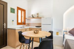 a small kitchen with a table and chairs in a room at Sun Beach Apartments in Karpathos