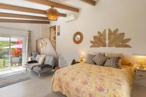 a bedroom with a bed and a couch and a chair at Le Pape - Chambre in Porticcio