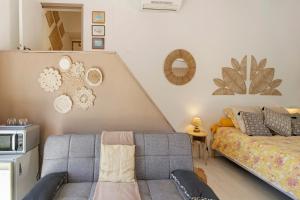 a living room with a couch and a bed at Le Pape - Chambre in Porticcio