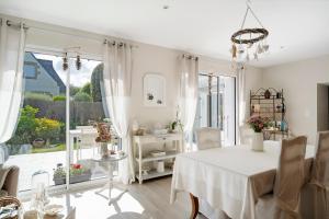 a white dining room with a table and a window at Rêves d'Emeraude in Cancale +25 photos