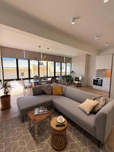 a living room with a couch and a table at Sitia Heights Apartment - Central Sea View in Sitia