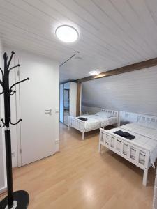 a room with two beds in a room with a door at Top-floor apartment for up to 3 guests in Dreieich