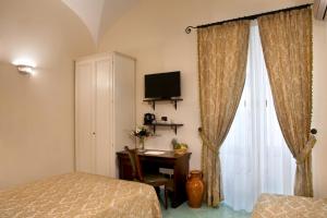 Postel nebo postele na pokoji v ubytování Albergo L'Antico Convitto