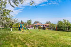 a large park with a playground with a slide at Хотелски комплекс Усоето in Elena