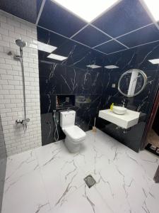 a bathroom with a toilet and a sink at Garden Villa 4, Ajman in Ajman 