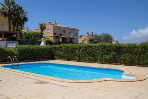a small blue swimming pool in front of a house at Villa BelaVista with Private Pool in Ferragudo