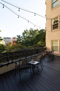 a group of chairs sitting on a deck with a view at Riverside Suites Resort 1BR Apartment in San Antonio
