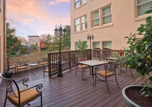 a wooden deck with tables and chairs on a building at Riverside Suites Resort 1BR Apartment in San Antonio
