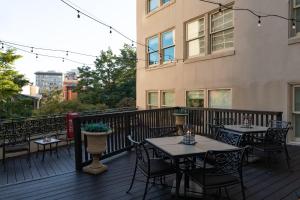 a deck with tables and chairs on a building at Riverside Suites Resort 1BR Apartment in San Antonio