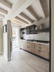 a large kitchen with wooden cabinets and a large counter at The Superhost - The Loft in Crotone