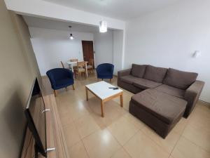 a living room with a couch and a table at Alto Valle Home in Cipolletti +1 photo