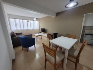 a living room with a table and chairs and a couch at Alto Valle Home in Cipolletti
