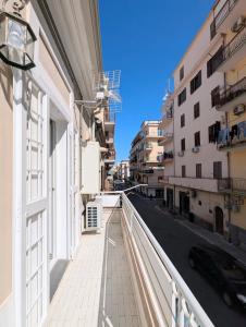 a balcony of a building with a view of a street at The Superhost - The Loft in Crotone