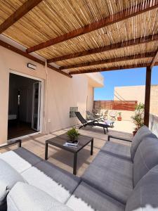 a living room with a couch and a table at Sitia Heights Apartment - Central Sea View in Sitia