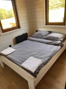 a bed in a small room with two towels on it at Domek w Skolitach in Skolity