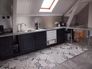 a kitchen with a sink and a counter top at Gites de la Haute Ville in Boulogne-sur-Mer