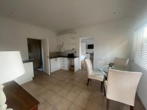 a kitchen and dining room with a table and chairs at Comfort & Convenience in Edenvale