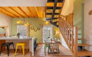 a kitchen with a staircase and a table and chairs at Ski Lodge Sierra Nevada in Sierra Nevada