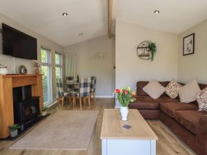 a living room with a couch and a table at Badgers Hollow Lodge in Windermere