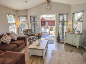 a living room with a couch and a table at Badgers Hollow Lodge in Windermere