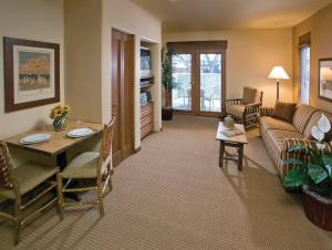 a living room with a couch and a table at Taos Resort Studio Apartment in Taos