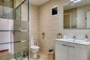 a bathroom with a toilet and a sink and a shower at Gîtes Villa Beau Soleil Agde in Agde +17 photos