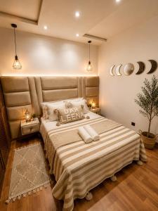 a bedroom with a large bed with two towels on it at dar leena in Essaouira