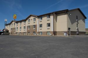 a large building with a parking lot in front of it at Super 8 by Wyndham Abilene KS in Abilene