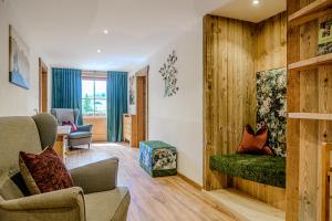 a living room with a couch and a chair at Zillertaler Hofchalets Schustererhof in Stumm
