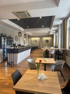 a restaurant with tables and chairs and a bar at Carina Hotel in Tczew