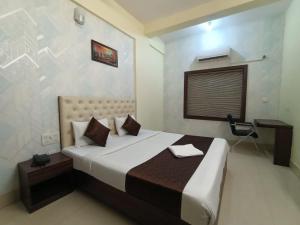a bedroom with a bed and a desk in it at Triple Tree Hotels and Resorts in Bhubaneshwar